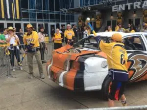 A father and son takes swings at the Ducks car on the plaza before Game 3. (Photo credit: ESPN 102.5 The Game / Ryan Porth)