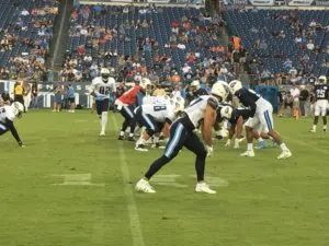 Nashville TN – August 5, 2017 – Nissan Stadium – Titans quarterback Marcus Mariota (in red) sends tight end Delanie Walker (#82) in motion during an intra-squad scrimmage (Photo by Buck Reising, ESPN Nashville).