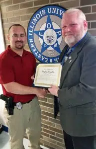 EIU Police Officer Stephen Szigethy, left, receives the FOP Meritorious Service Award from FOP State Lodge President Chris Southwood. 