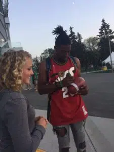 Rider Duron Carter signs the football he caught one-handed for a touchdown against the Toronto Argonauts on July 29, 2017. (Michelle Hansen/Twitter)