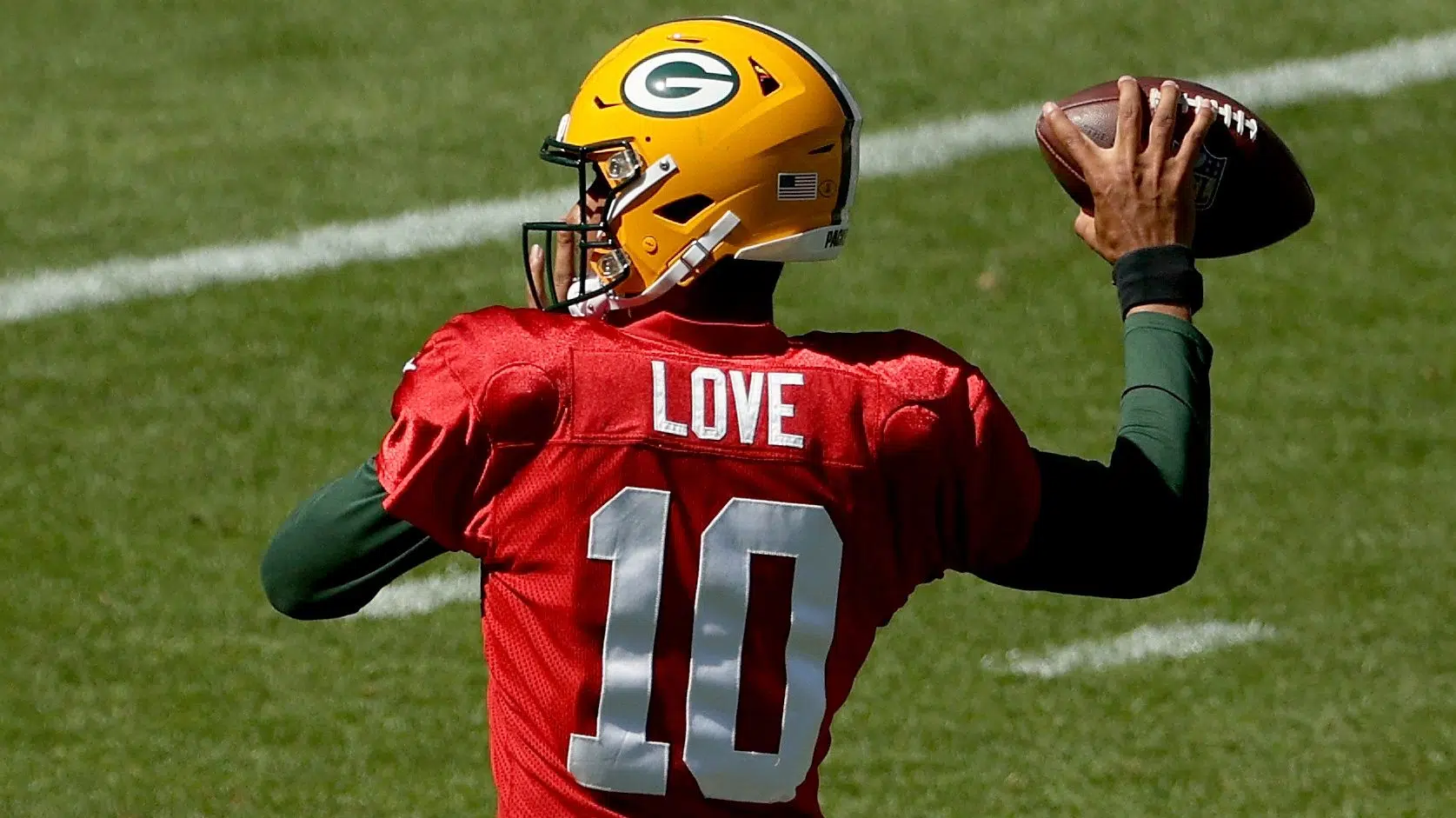 Christian Watson of the Green Bay Packers warms up before the