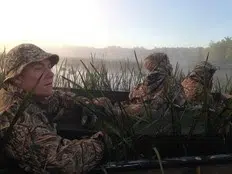 an adult with two youth during a previous youth waterfowl hunt