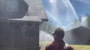 Yellowhead County Fire Department firefighters set up structure protection sprinklers