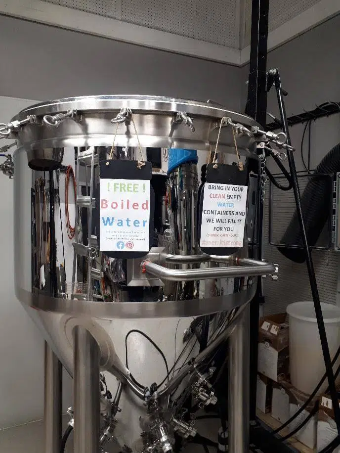 Empty Keg using empty beer kettles to boil water for residents Q101