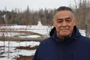 Project Manager Lewis Cardinal standing on the kihcihkaw askî (Sacred Land) site (Photo Credits - Daniel Barker-Tremblay)