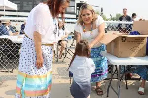 Little one getting his gift from Early Years Staff (Photo Credits - Daniel Barker-Tremblay)