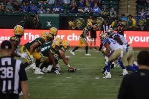 Edmonton Elks facing off in the line of scrimmage against the Winnipeg Blue Bombers with the Indigenous Logo (Photo Credits - Daniel Barker-Tremblay) 