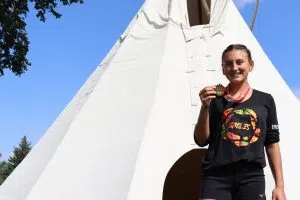 Treaty Six Eagles Player Raylee Tremblay all smiles holding up the AIG Gold (Photo Credits - Daniel Barker-Tremblay)