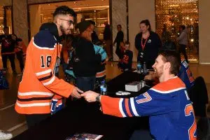 Edmonton Oilers #27 Brett Kulak all smiles signing a jersey for an Oilers fan at West Edmonton Mall (Photo Credits - Edmonton Oilers Entertainment Group)