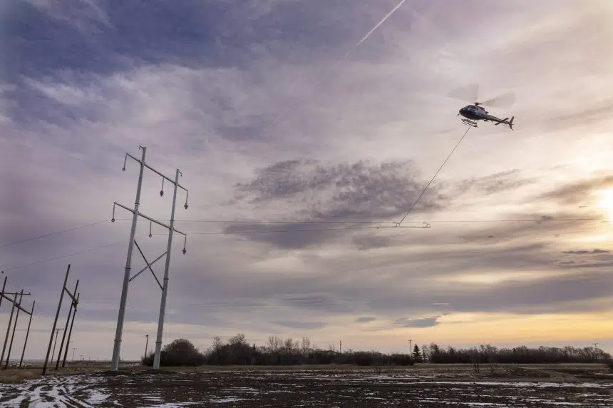 Chopper installing power lines over Highway 1 near Rush Lake | 980 CJME