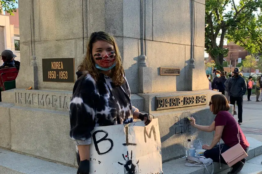‘We can’t entice the police:’ protesters clean up graffiti at city hall war memorial